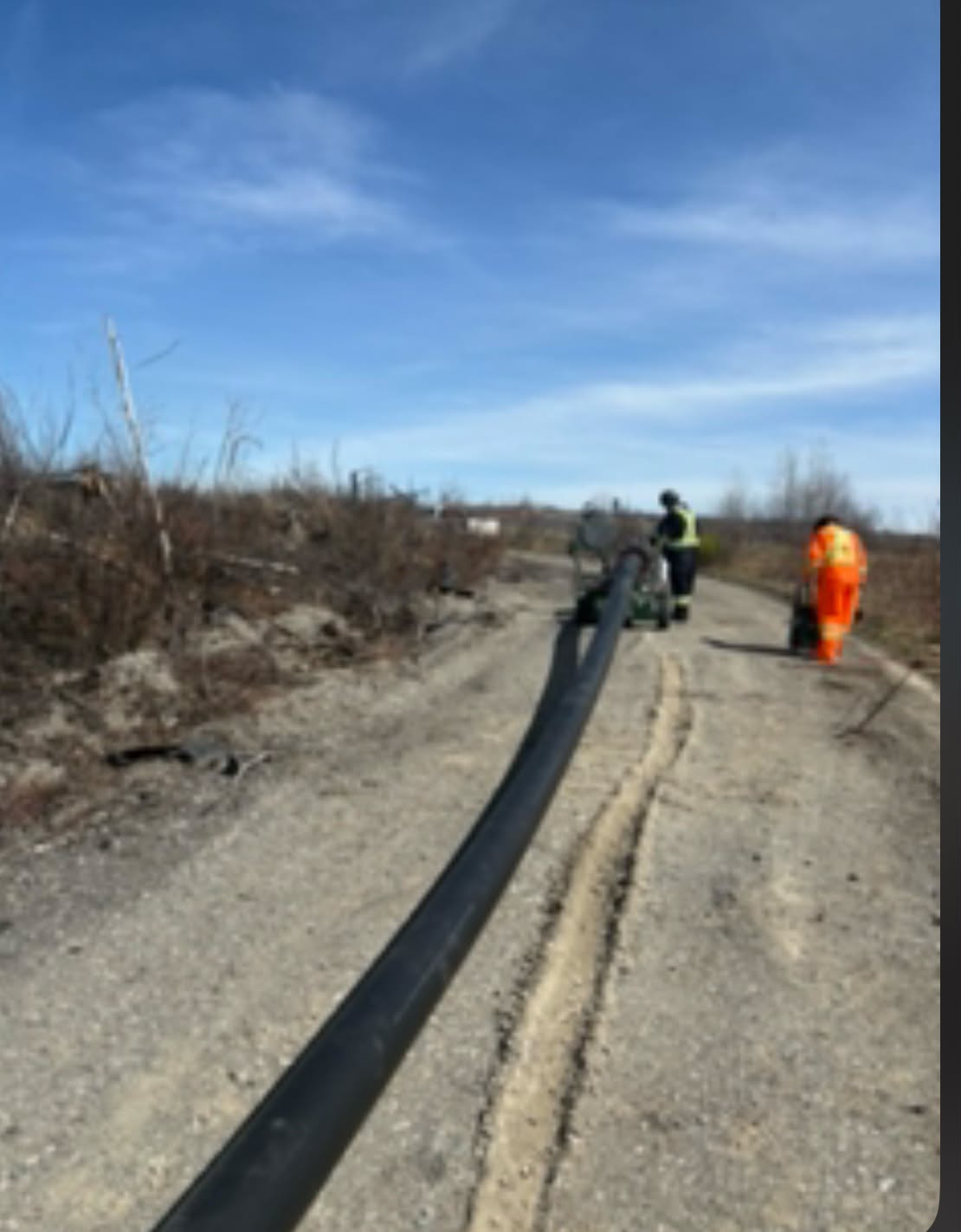 Field crew and equipment on a mine-site access road