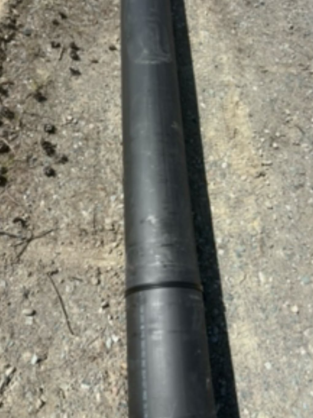 HDPE pipeline running alongside a mine-site haul road